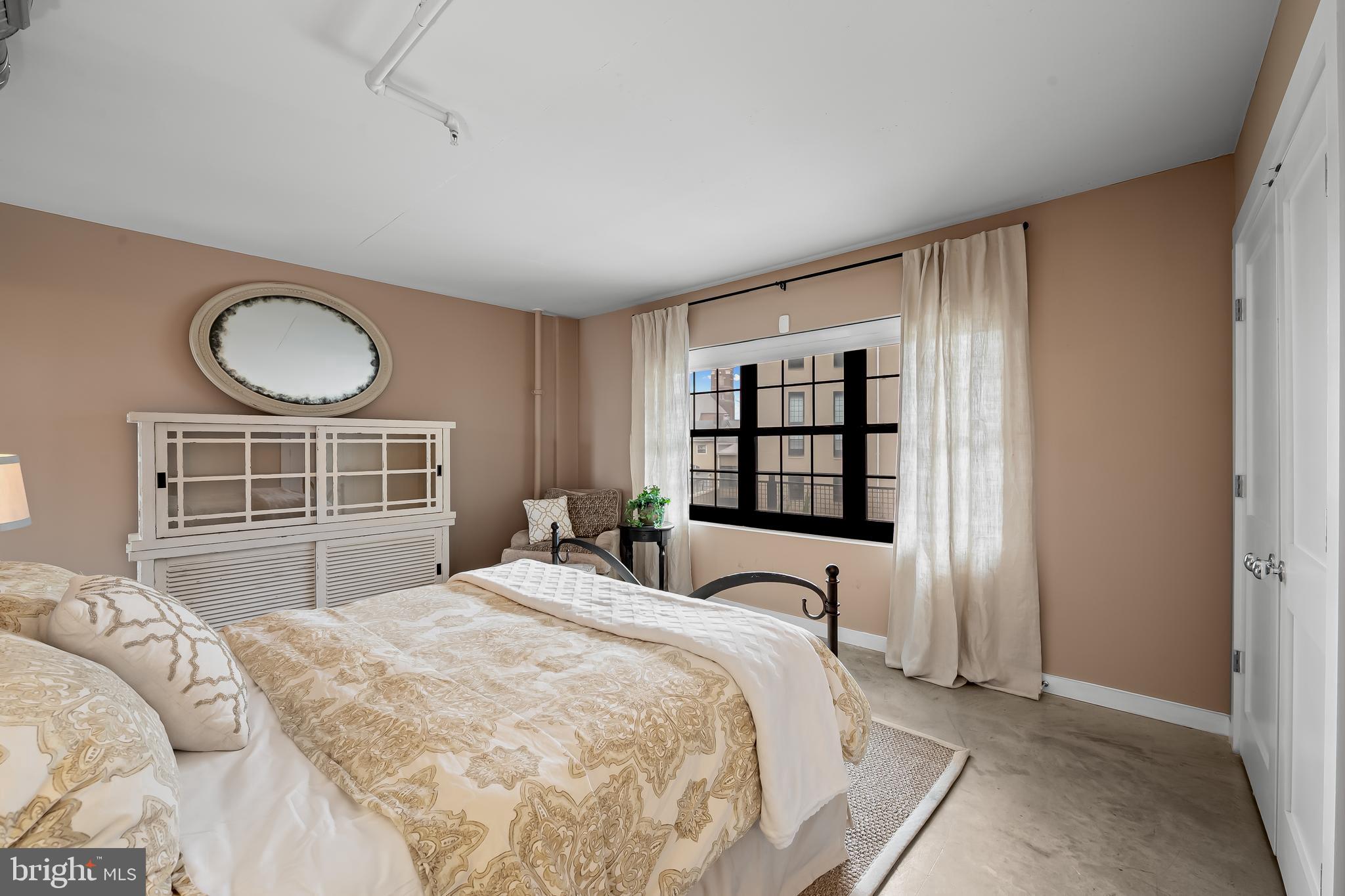 1220 Bank Street, Unit 309 Baltimore, MD 21202 - Photo 27 of 56 a bedroom with a bed and a window