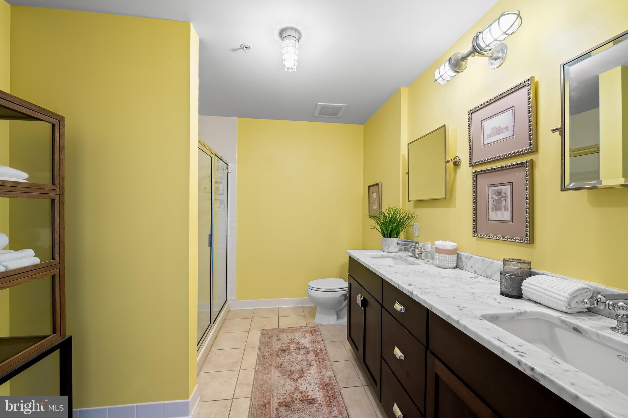 1220 Bank Street, Unit 309 Baltimore, MD 21202 - Photo 29 of 56 a spacious bathroom with a granite countertop sink and a mirror