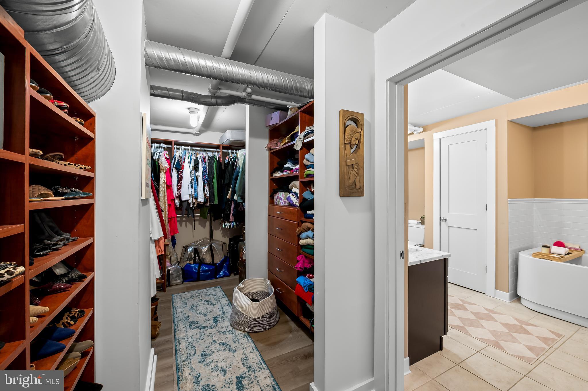 1220 Bank Street, Unit 309 Baltimore, MD 21202 - Photo 37 of 56 a view of walk in closet with clothes and shoes