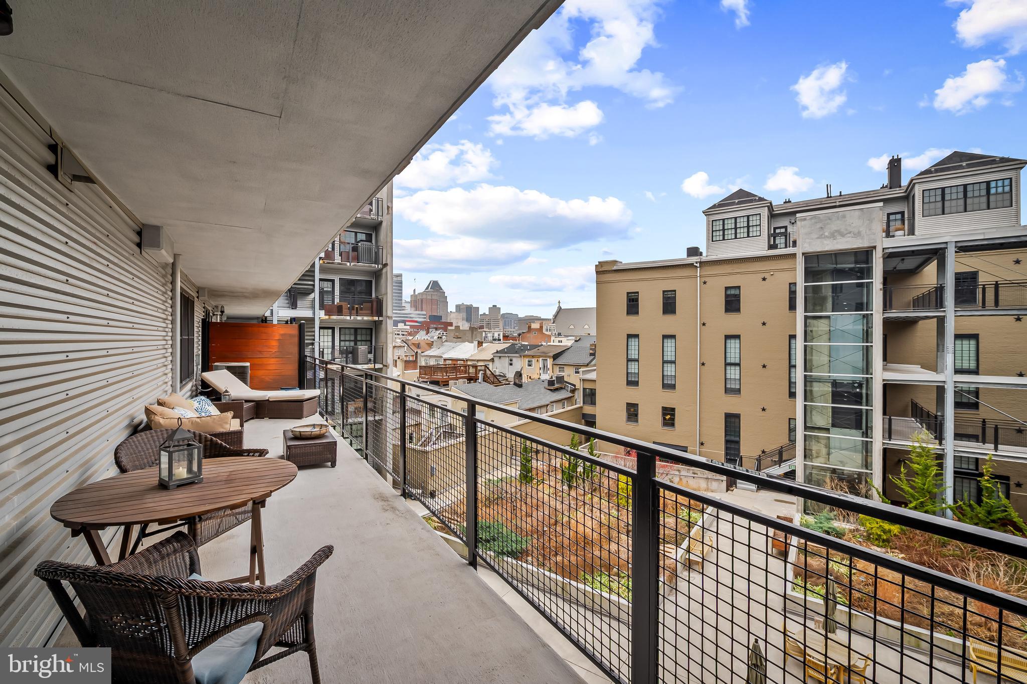1220 Bank Street, Unit 309 Baltimore, MD 21202 - Photo 41 of 56 a balcony with view of chairs and wooden floor