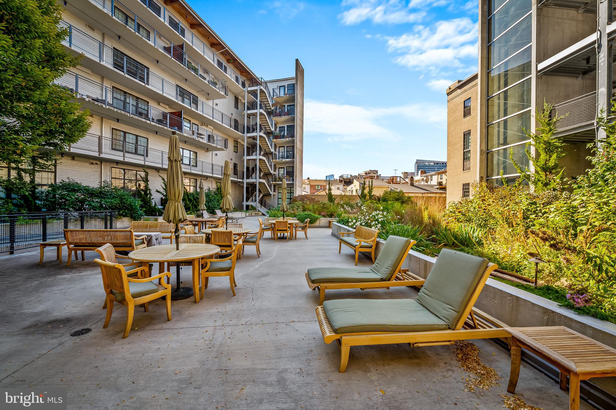 1220 Bank Street, Unit 309 Baltimore, MD 21202 - Photo 48 of 56 a view of a patio with a table and chairs