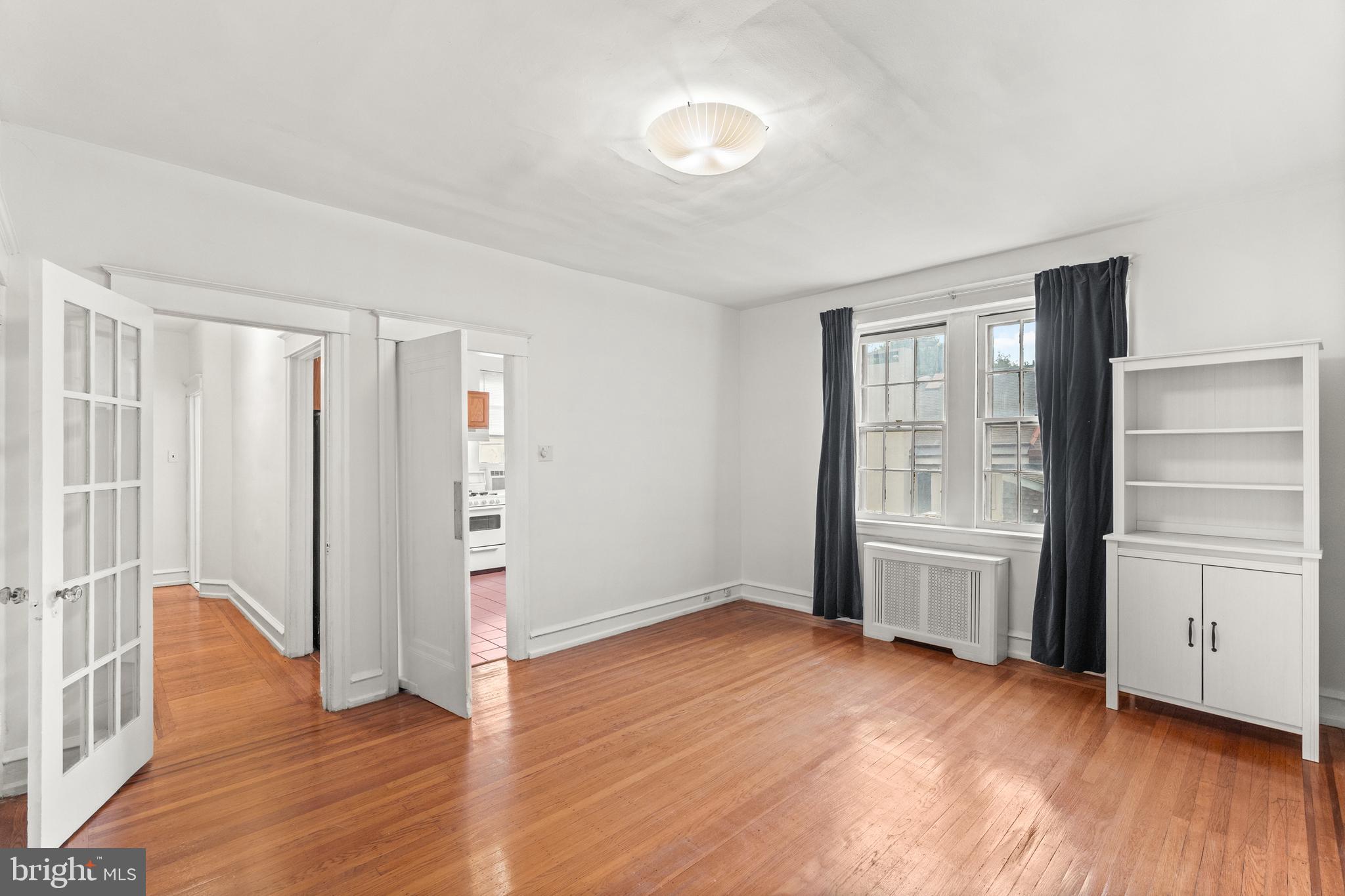 409 Pine Street, Unit 3 Philadelphia, PA 19106 - Photo 11 of 30 an empty room with wooden floor cabinet and windows