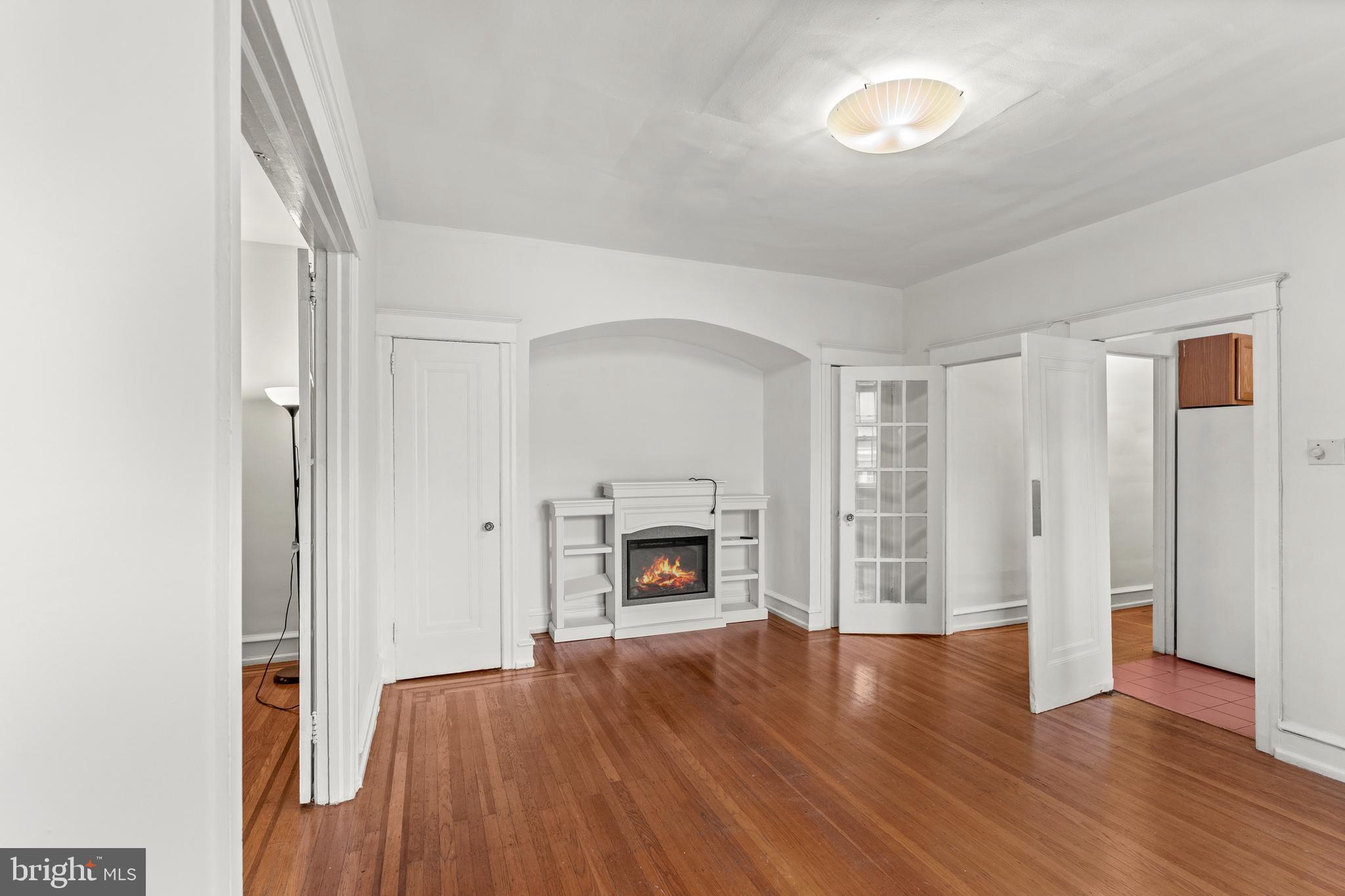 409 Pine Street, Unit 3 Philadelphia, PA 19106 - Photo 12 of 30 an empty room with wooden floor fireplace and cabinet
