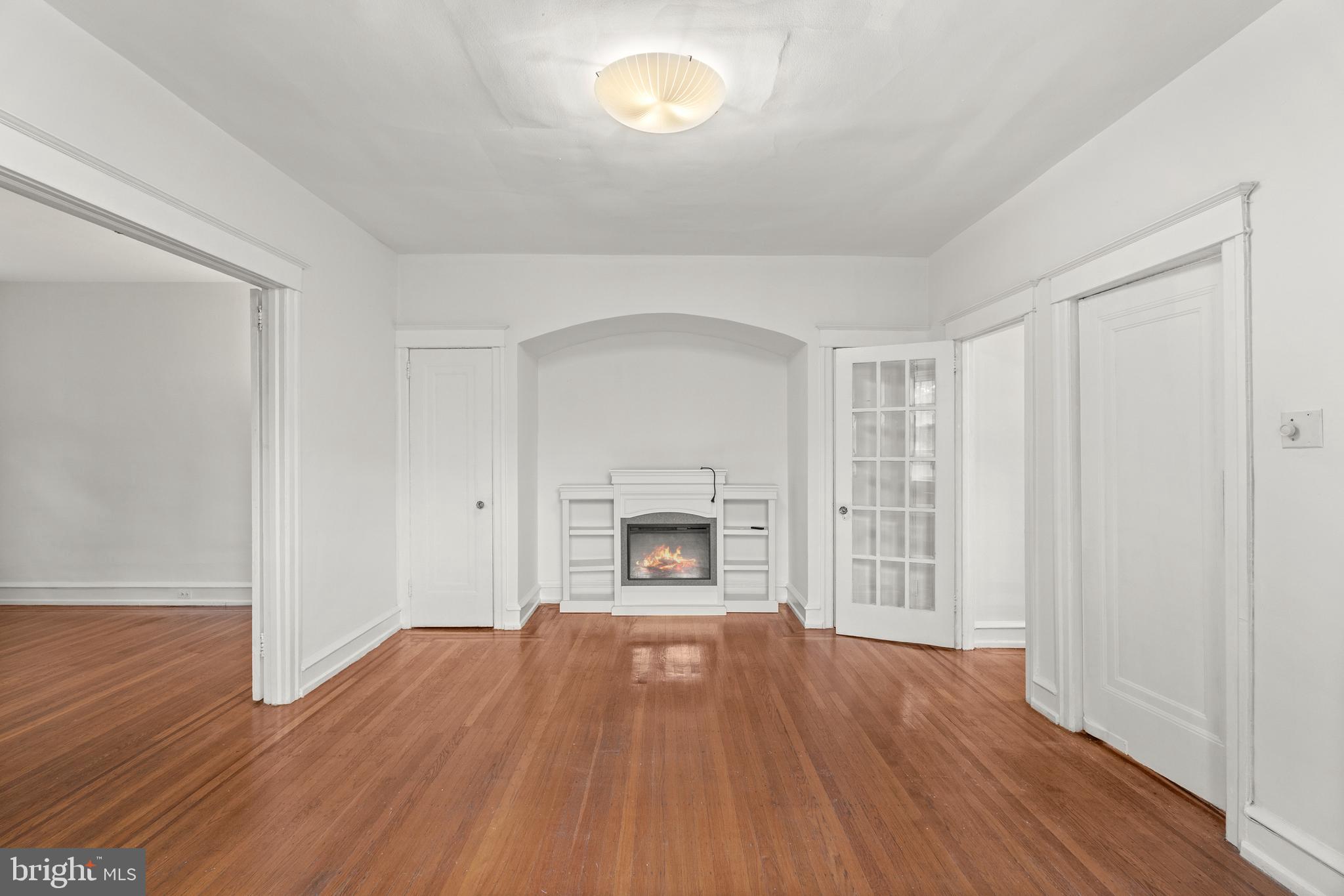 409 Pine Street, Unit 3 Philadelphia, PA 19106 - Photo 13 of 30 an empty room with wooden floor fireplace and windows