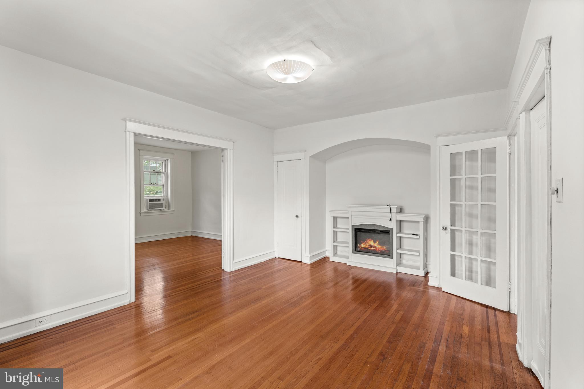 409 Pine Street, Unit 3 Philadelphia, PA 19106 - Photo 14 of 30 an empty room with wooden floor fireplace and windows