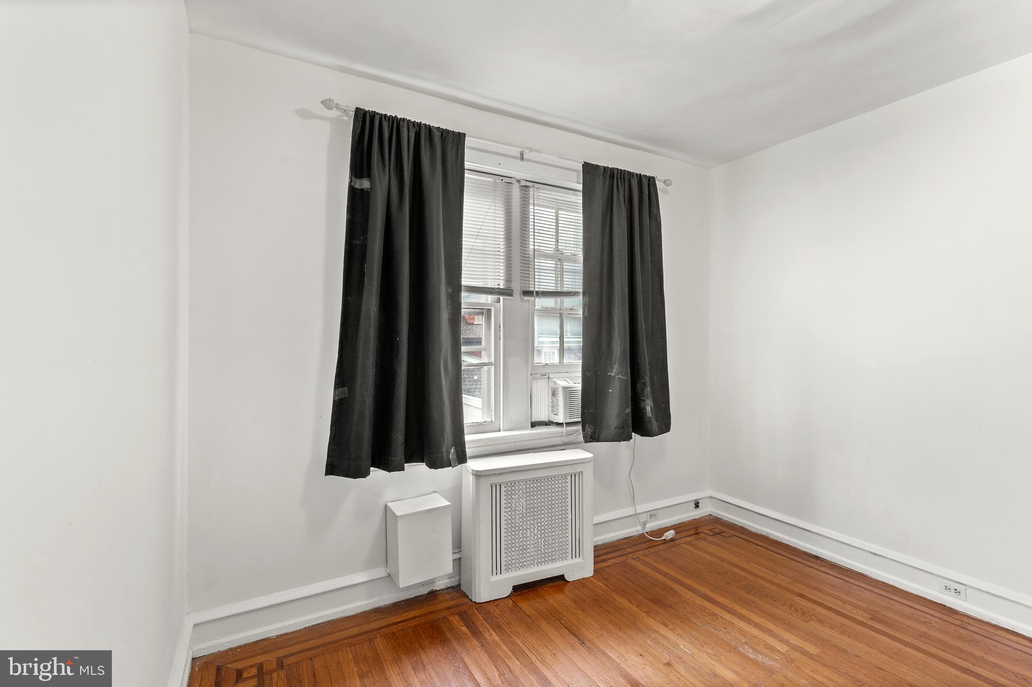409 Pine Street, Unit 3 Philadelphia, PA 19106 - Photo 26 of 30 an empty room with wooden floor and windows