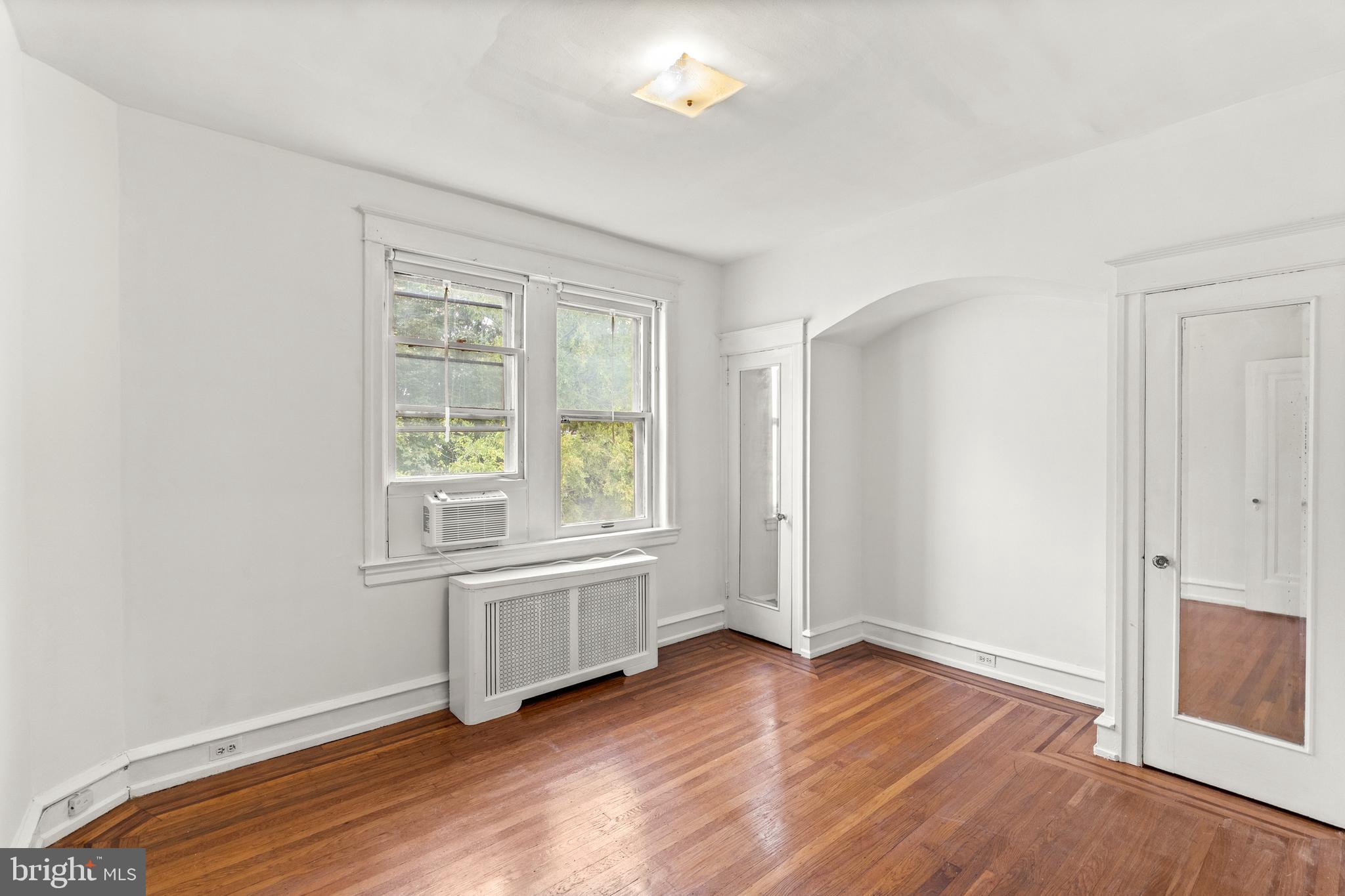 409 Pine Street, Unit 3 Philadelphia, PA 19106 - Photo 27 of 30 an empty room with wooden floor and windows