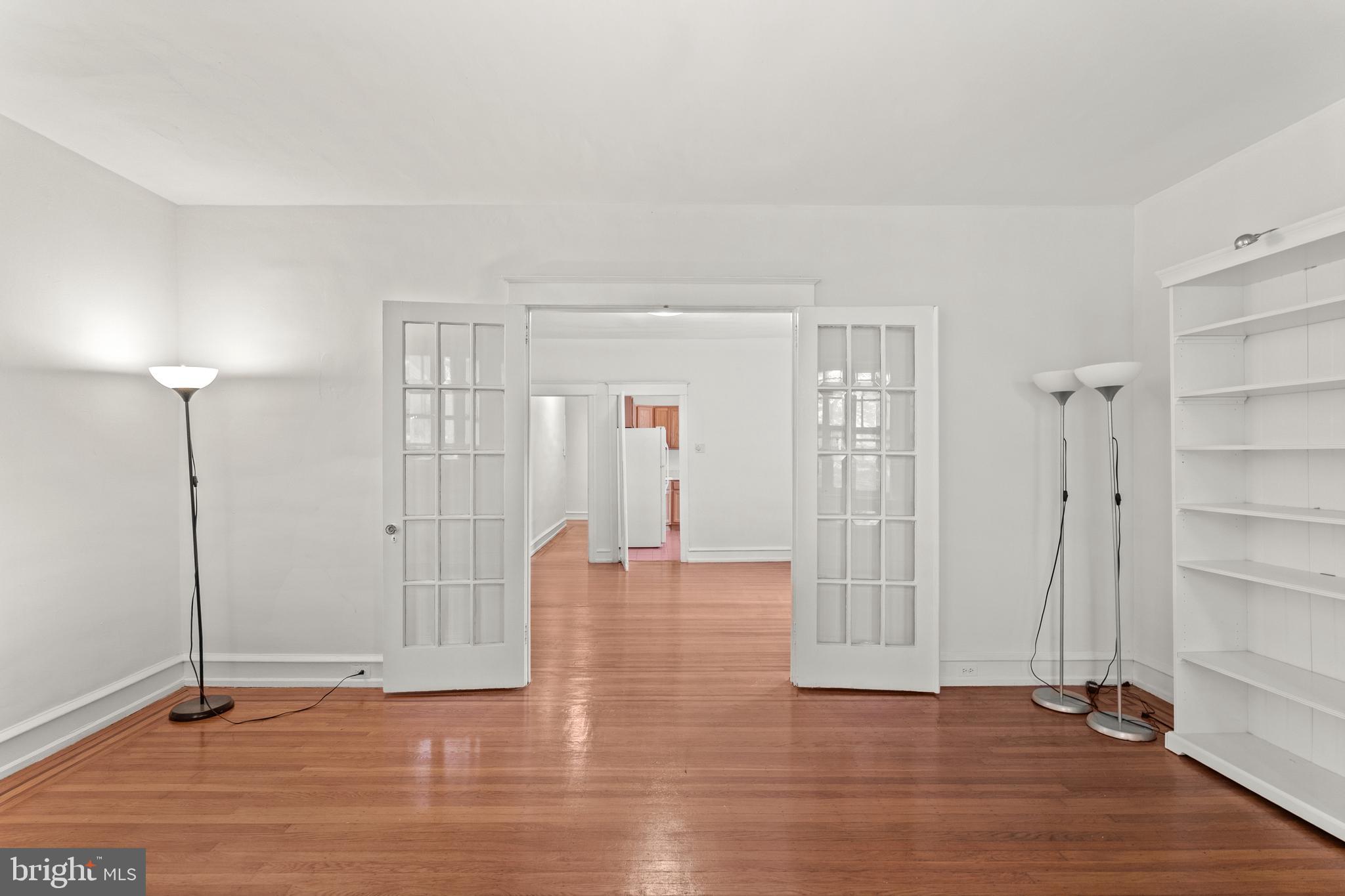 409 Pine Street, Unit 3 Philadelphia, PA 19106 - Photo 3 of 30 an empty room with wooden floor and windows