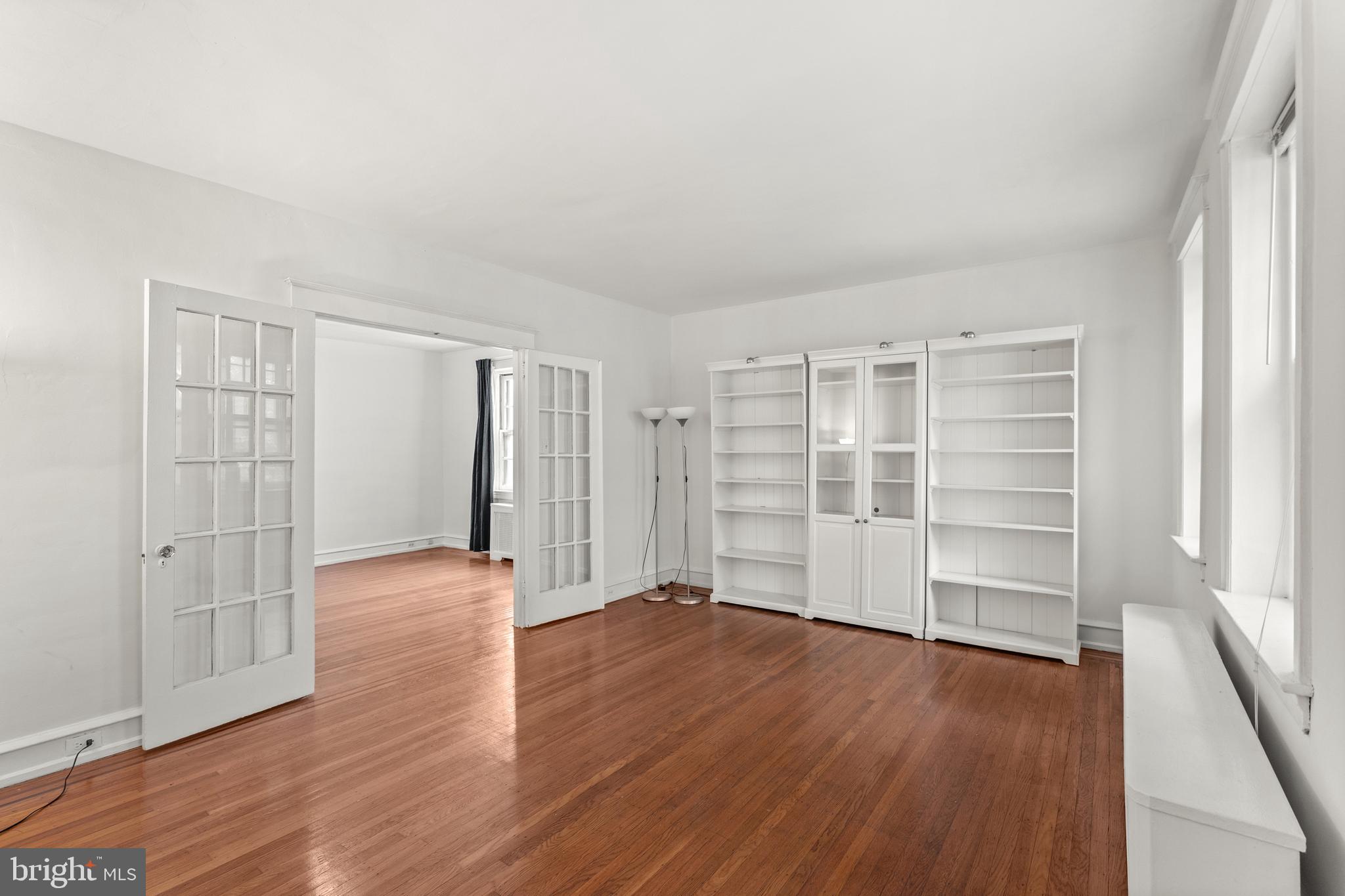 409 Pine Street, Unit 3 Philadelphia, PA 19106 - Photo 4 of 30 an empty room with wooden floor closet and windows