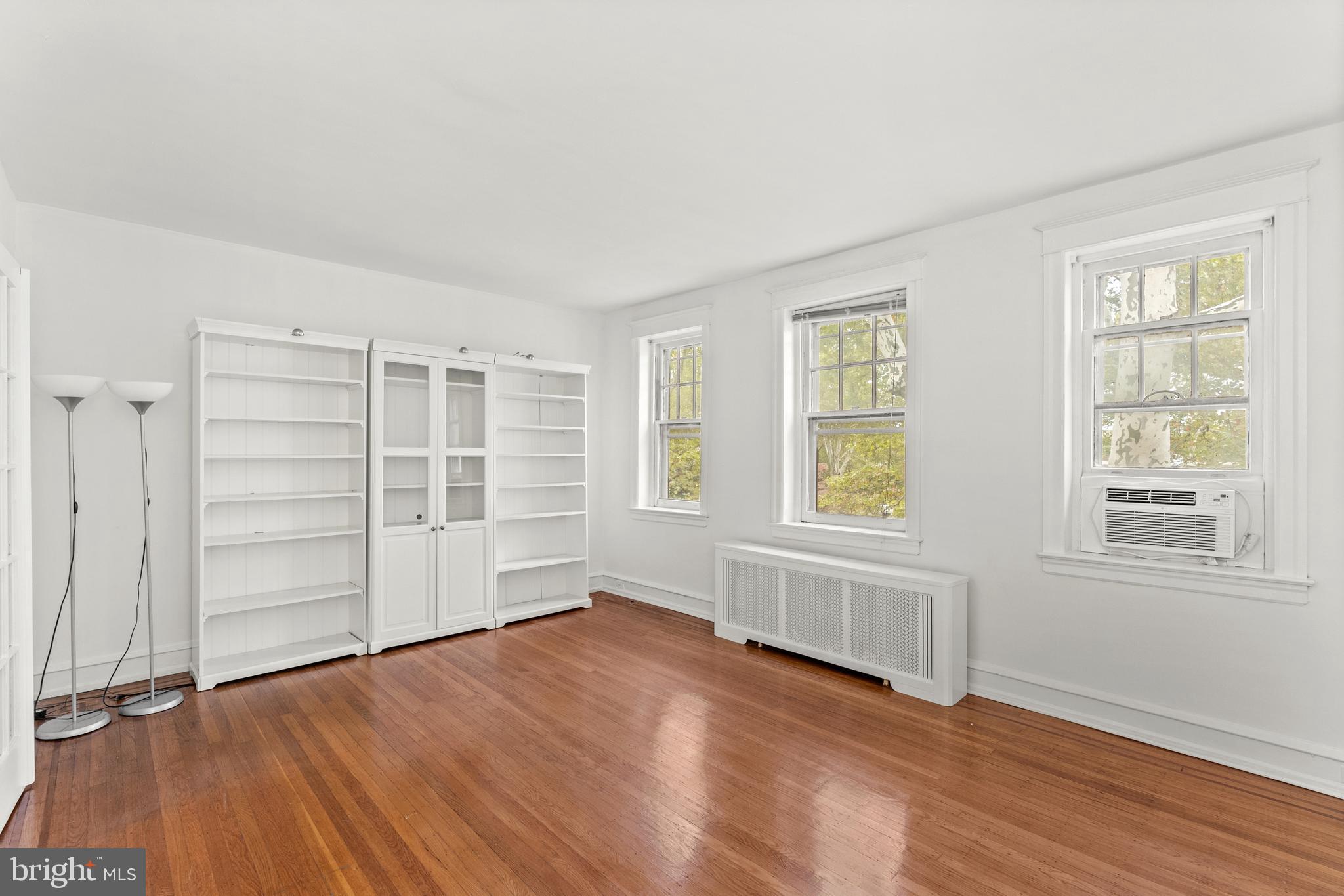 409 Pine Street, Unit 3 Philadelphia, PA 19106 - Photo 5 of 30 an empty room with wooden floor closet and windows