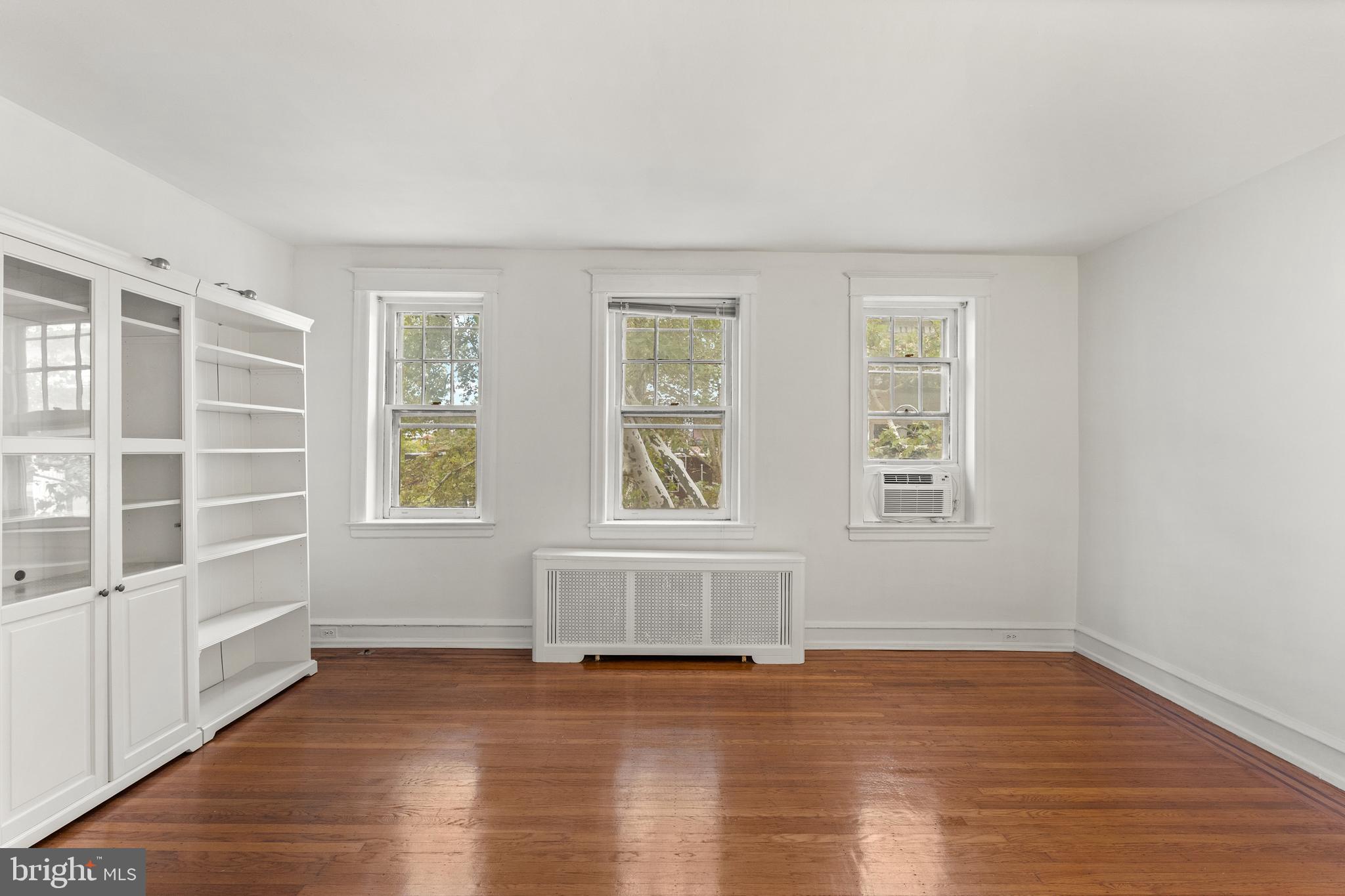 409 Pine Street, Unit 3 Philadelphia, PA 19106 - Photo 6 of 30 an empty room with wooden floor and windows