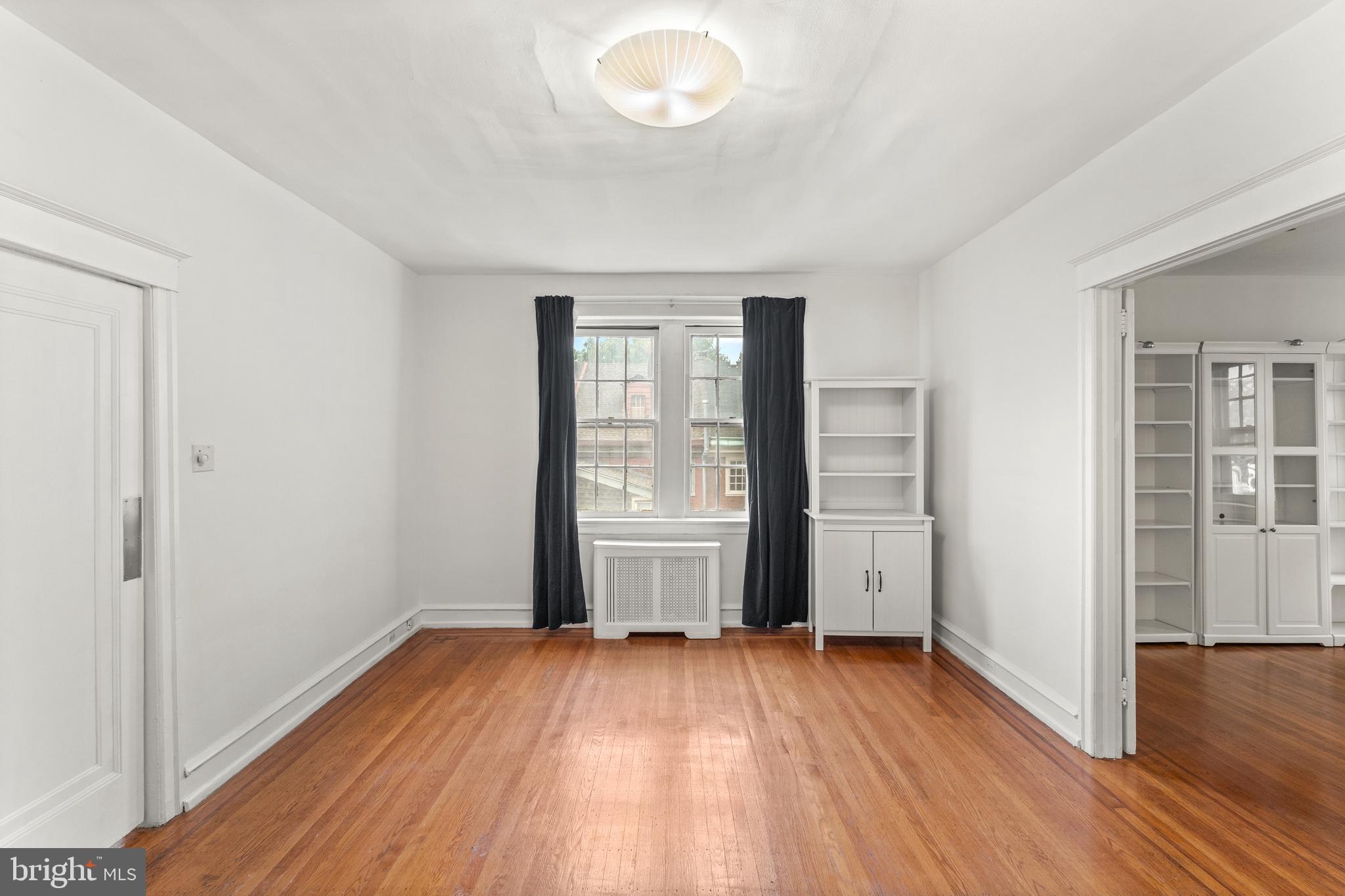 409 Pine Street, Unit 3 Philadelphia, PA 19106 - Photo 10 of 30 an empty room with wooden floor and windows