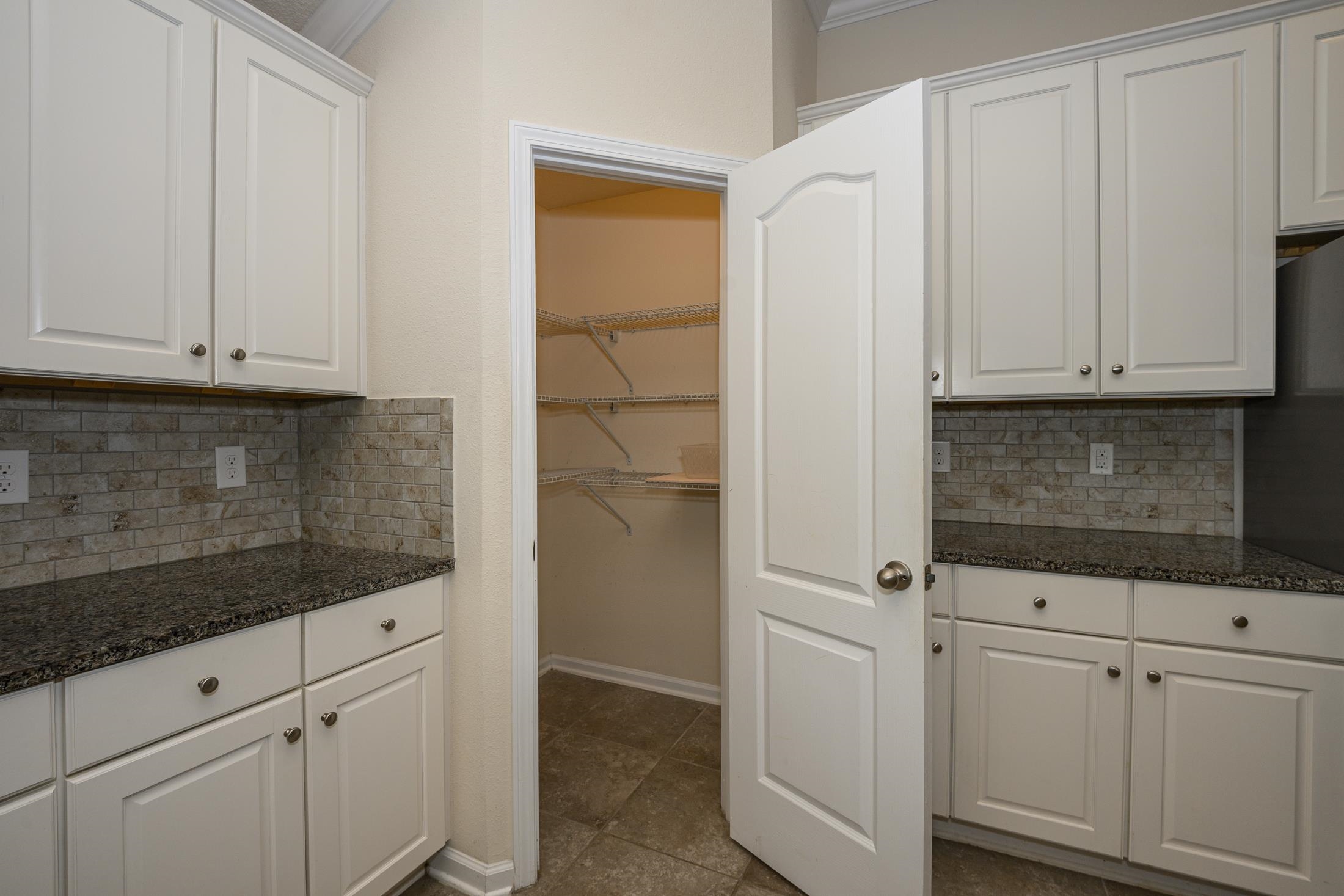 772 Pullman Circle St. Augustine, FL 32084 - Photo 23 of 77 a kitchen with white cabinets and white appliances