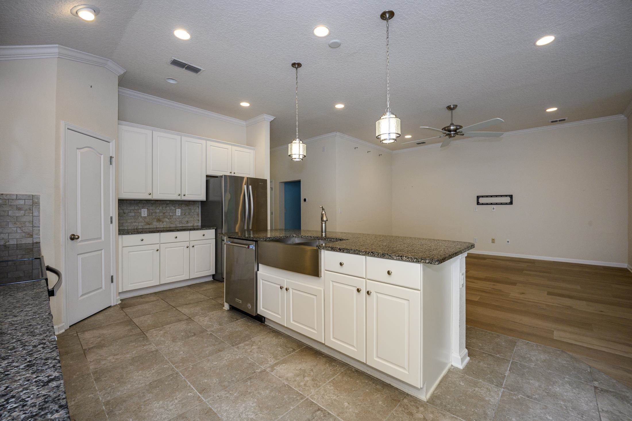 772 Pullman Circle St. Augustine, FL 32084 - Photo 24 of 77 a kitchen that has a lot of cabinets and wooden floor