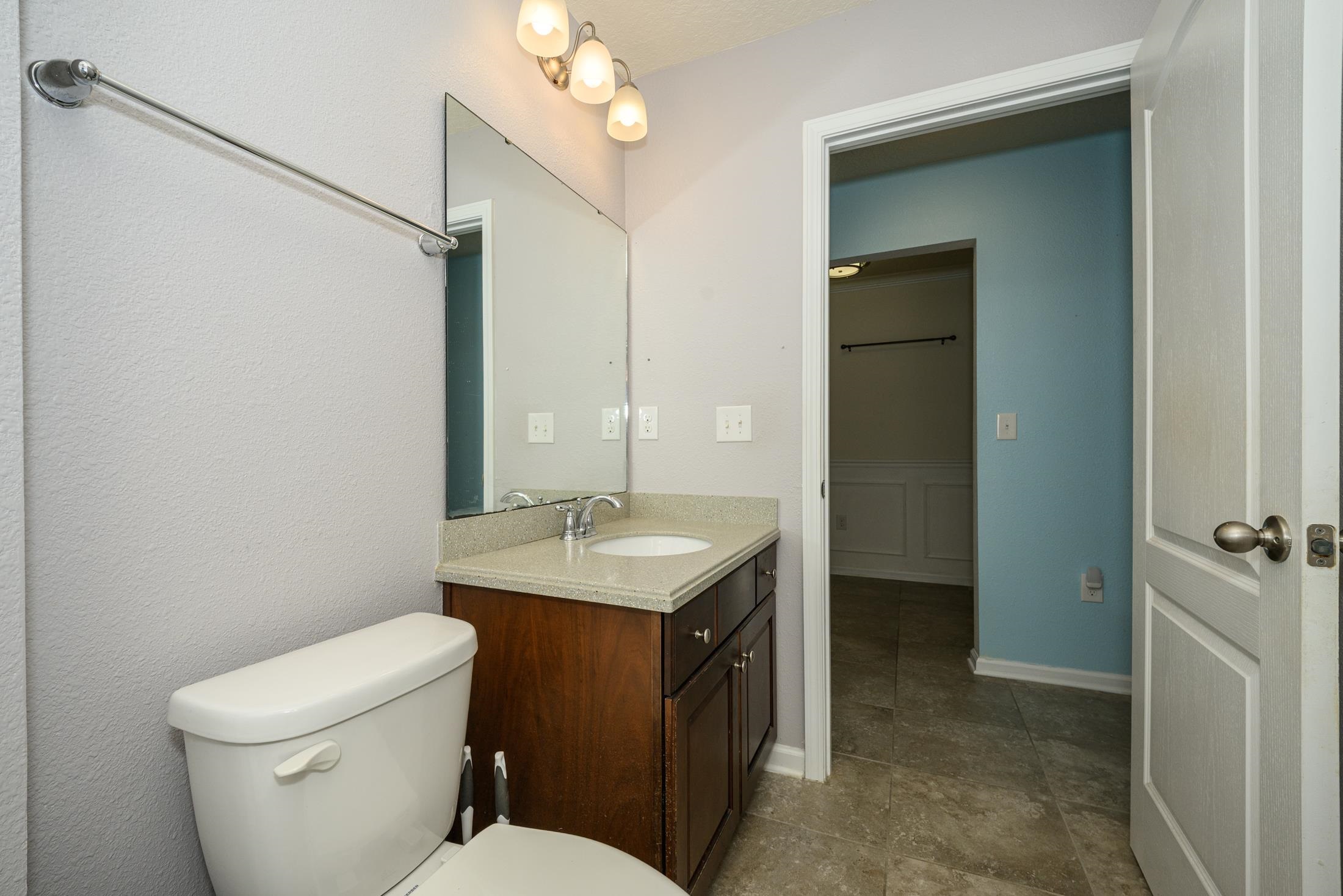 772 Pullman Circle St. Augustine, FL 32084 - Photo 31 of 77 a bathroom with a toilet a sink and mirror