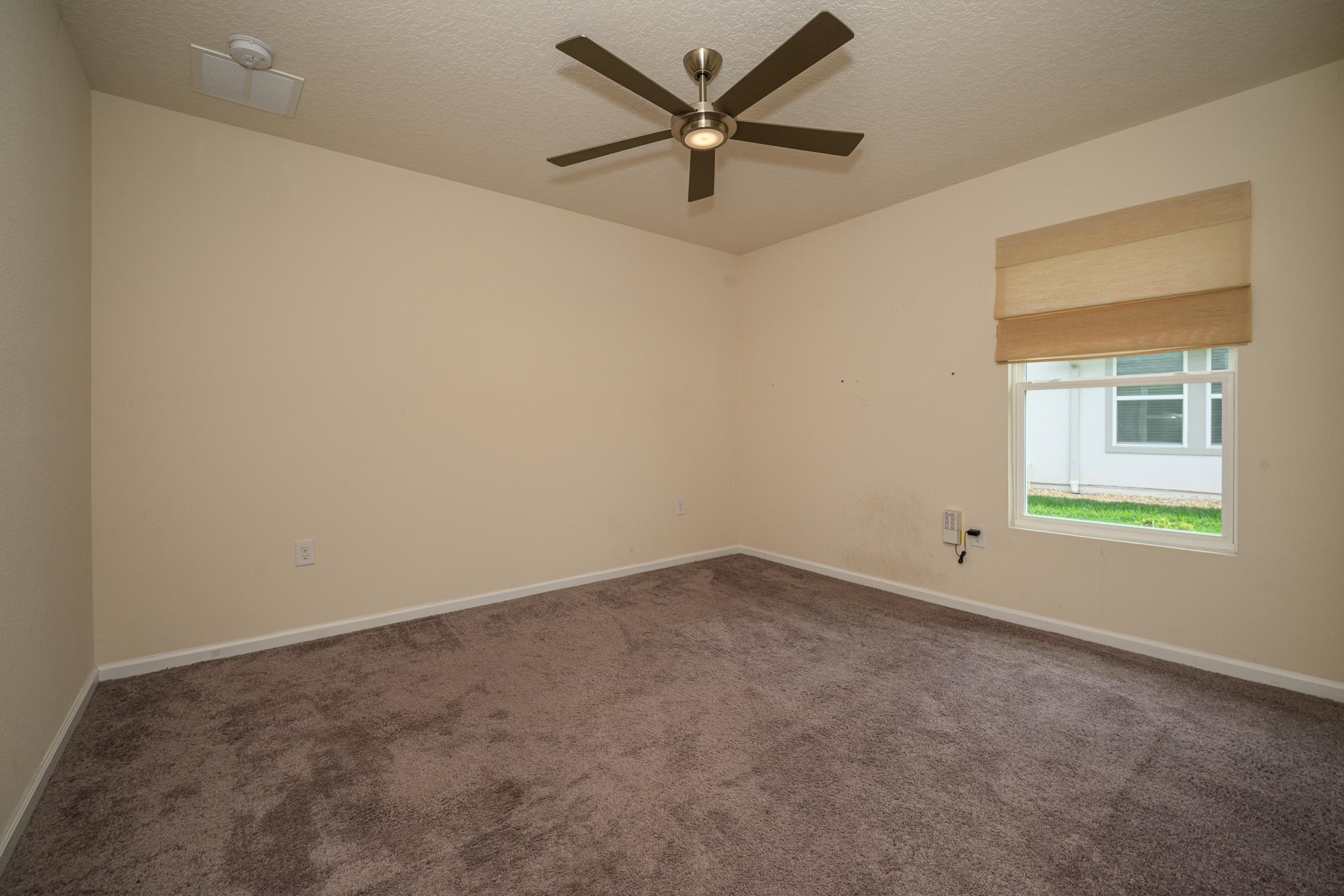 772 Pullman Circle St. Augustine, FL 32084 - Photo 32 of 77 an empty room with a window and a fan