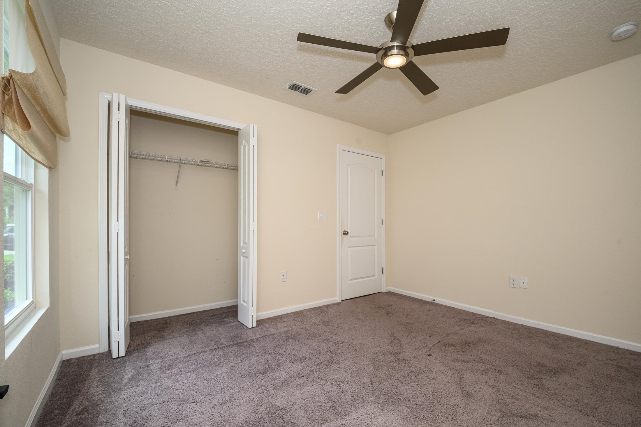 772 Pullman Circle St. Augustine, FL 32084 - Photo 34 of 77 an empty room with windows and fan