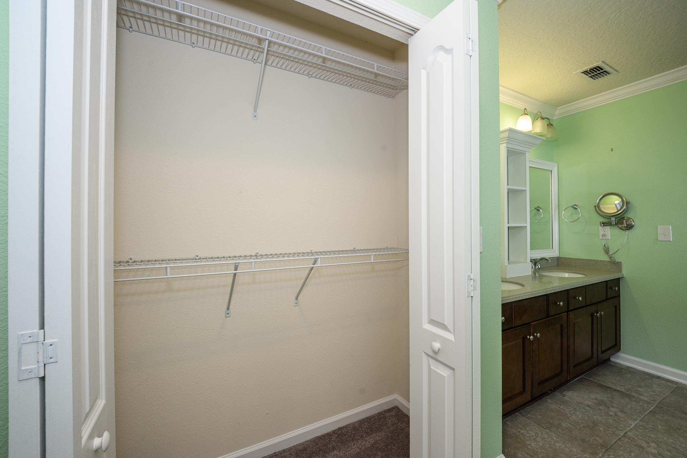 772 Pullman Circle St. Augustine, FL 32084 - Photo 50 of 77 a bathroom with a granite countertop sink and mirror