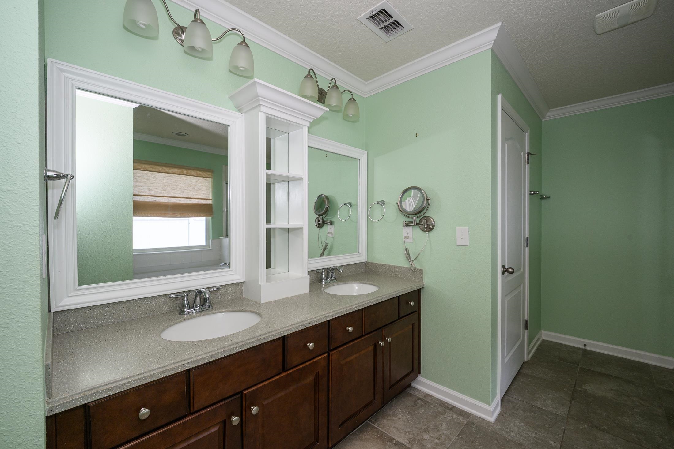 772 Pullman Circle St. Augustine, FL 32084 - Photo 51 of 77 a bathroom with a granite countertop sink a mirror and a shower