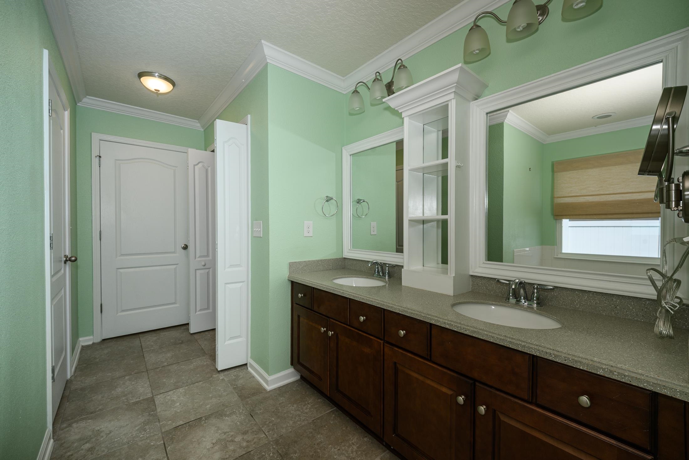 772 Pullman Circle St. Augustine, FL 32084 - Photo 56 of 77 a bathroom with a granite countertop sink mirror and double
