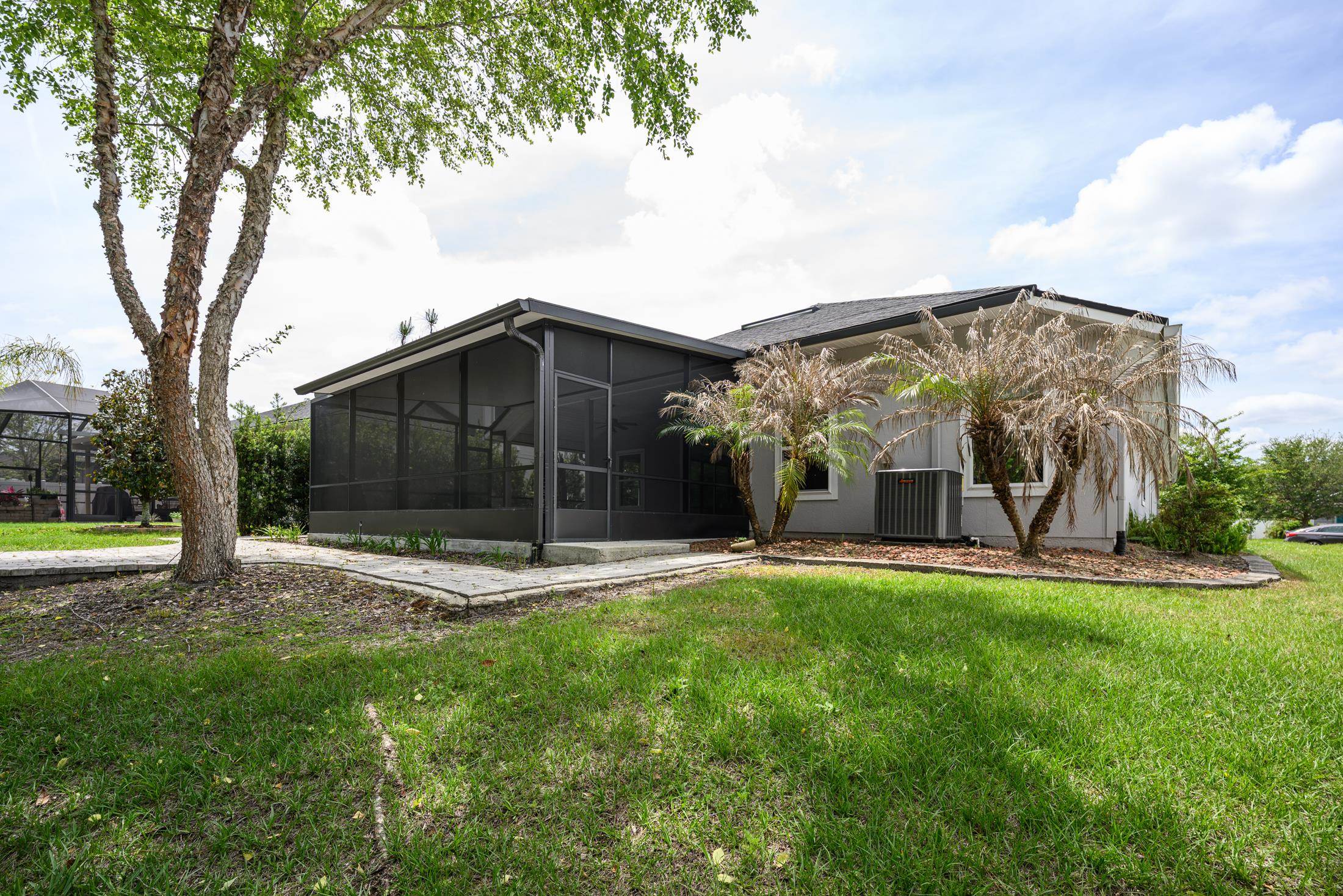 772 Pullman Circle St. Augustine, FL 32084 - Photo 59 of 77 a view of a tiny house with a big yard and large trees