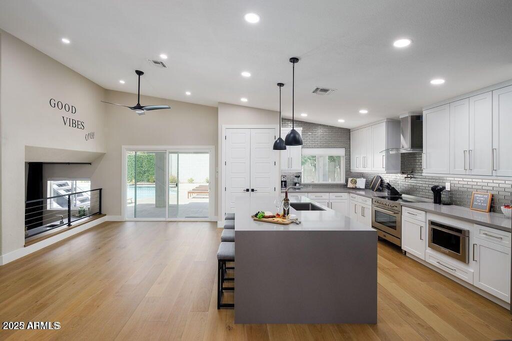 6174 East Janice Way Scottsdale, AZ 85254 - Photo 11 of 39 a large white kitchen with lots of counter space a sink refrigerator and cabinets