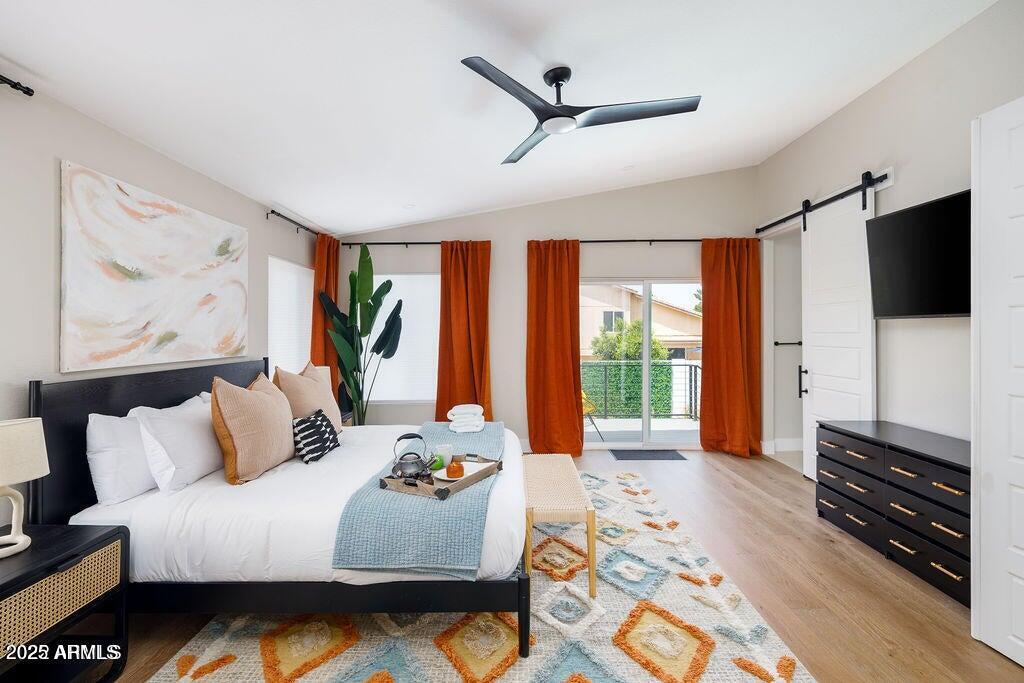 6174 East Janice Way Scottsdale, AZ 85254 - Photo 17 of 39 a bedroom with a bed a flat screen tv and a large window