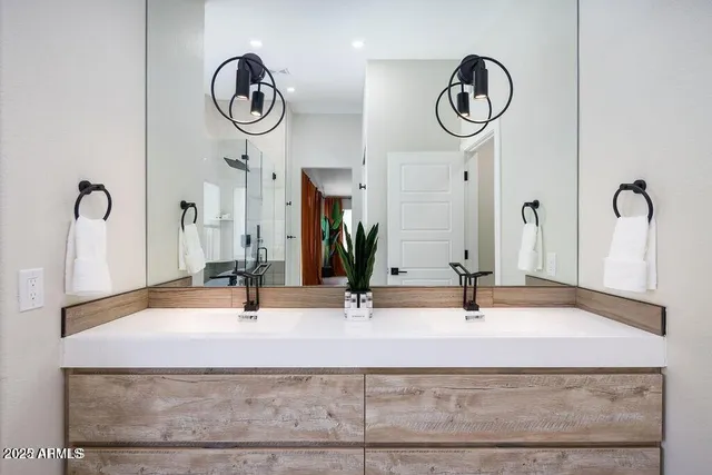 a bathroom with a double vanity sink and a mirror