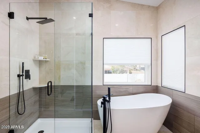 a bathroom with a granite countertop sink a toilet and shower