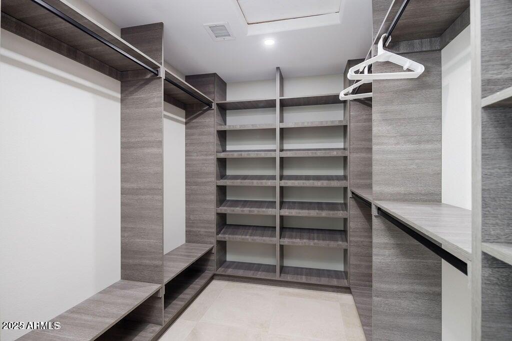 6174 East Janice Way Scottsdale, AZ 85254 - Photo 23 of 39 a view of walk in closet with empty racks