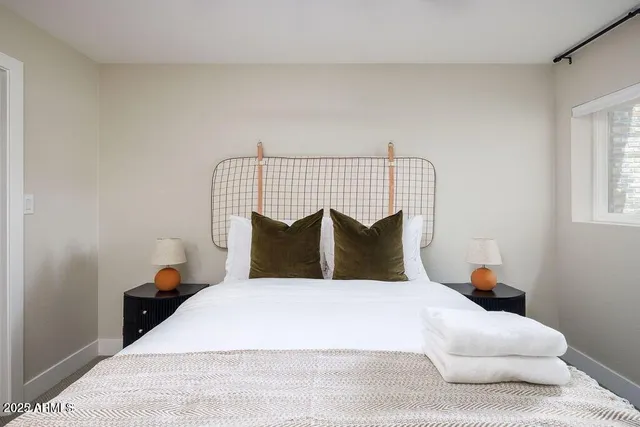 a bedroom with a bed and window