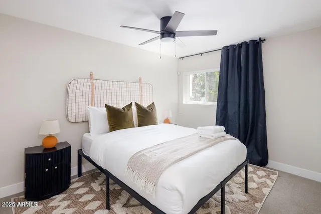 a bedroom with a bed and a table