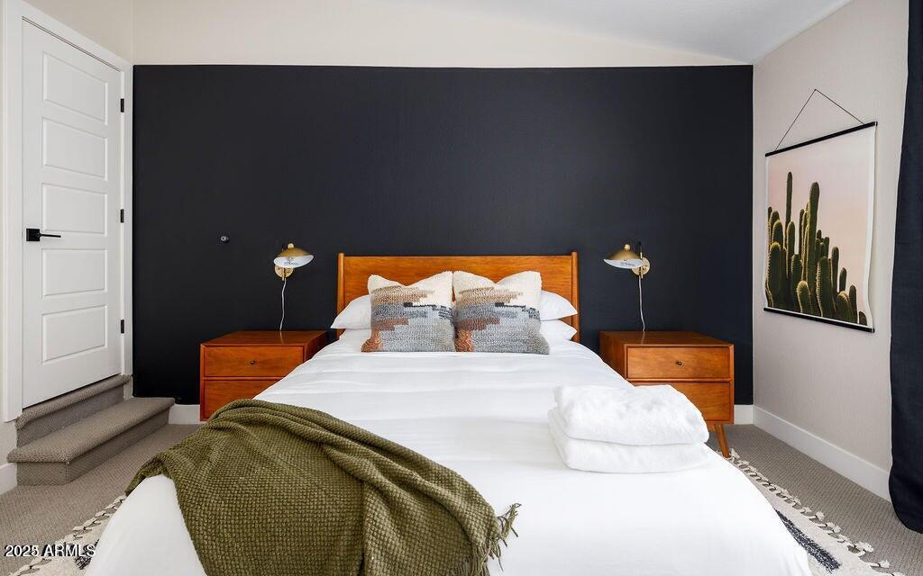 6174 East Janice Way Scottsdale, AZ 85254 - Photo 29 of 39 a bedroom with a bed and wooden floor