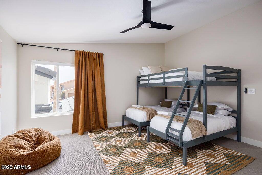 6174 East Janice Way Scottsdale, AZ 85254 - Photo 30 of 39 a bedroom with a bed and wooden floor