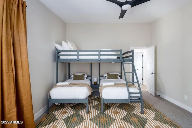 a bedroom with two beds and a table