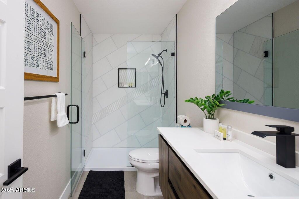 6174 East Janice Way Scottsdale, AZ 85254 - Photo 32 of 39 a bathroom with a sink toilet and shower