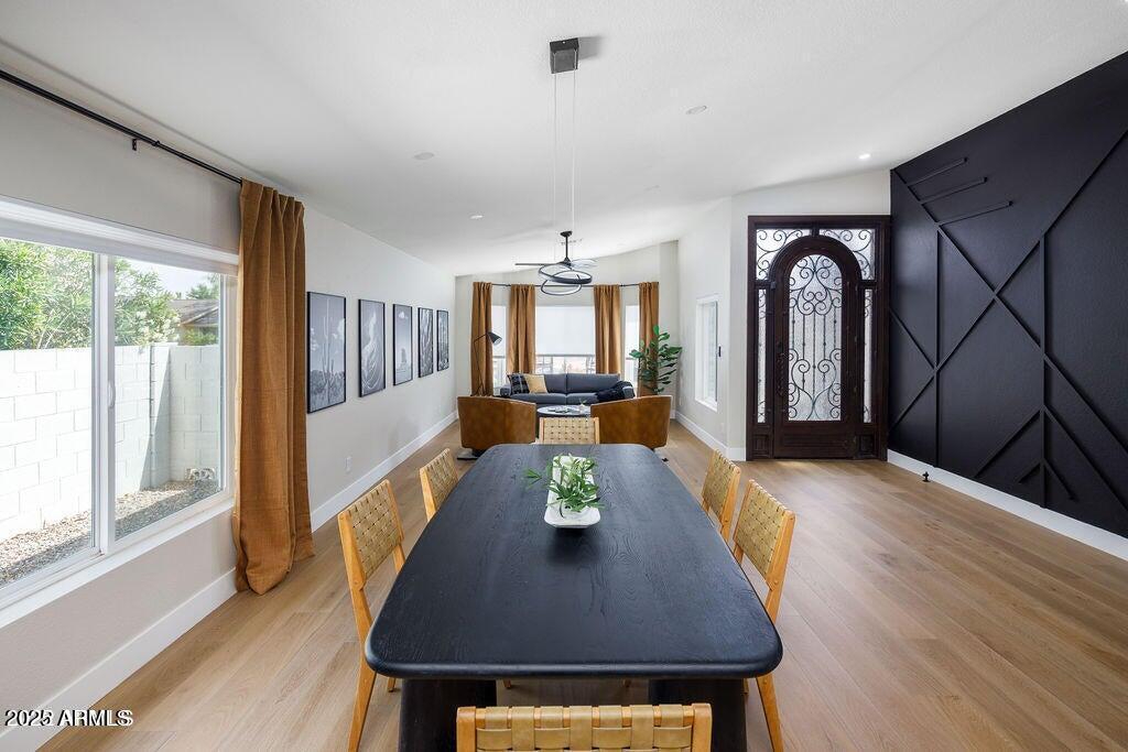 6174 East Janice Way Scottsdale, AZ 85254 - Photo 4 of 39 a view of a dining room with furniture window and wooden floor