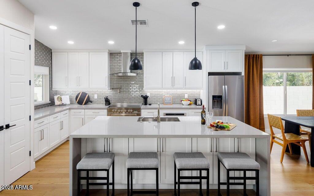 6174 East Janice Way Scottsdale, AZ 85254 - Photo 8 of 39 a kitchen with refrigerator a sink and chairs