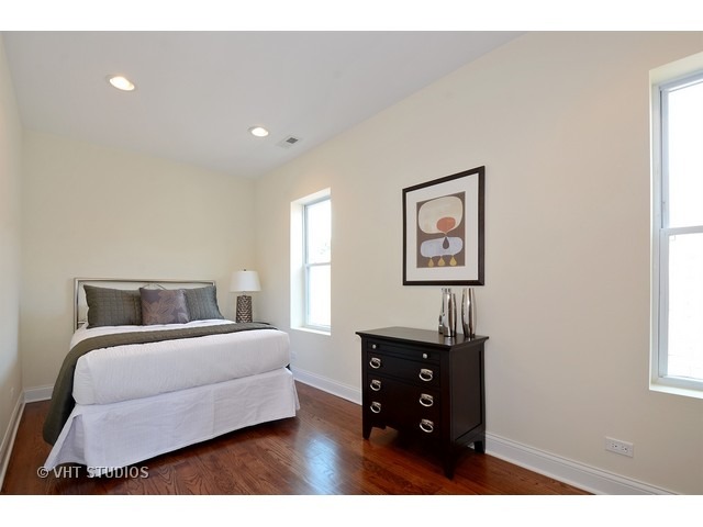 3323 North Troy Street Chicago, IL 60618 - Photo 13 of 25 a bedroom with a bed and a night stand
