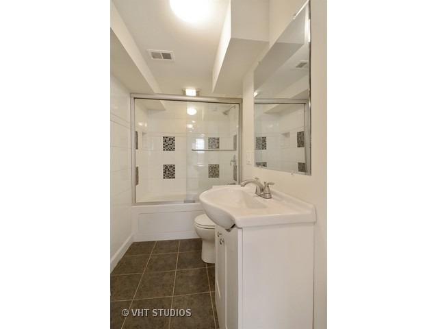 3323 North Troy Street Chicago, IL 60618 - Photo 14 of 25 a bathroom with a sink a toilet and shower