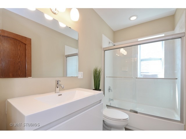 3323 North Troy Street Chicago, IL 60618 - Photo 17 of 25 a bathroom with a sink a toilet and shower
