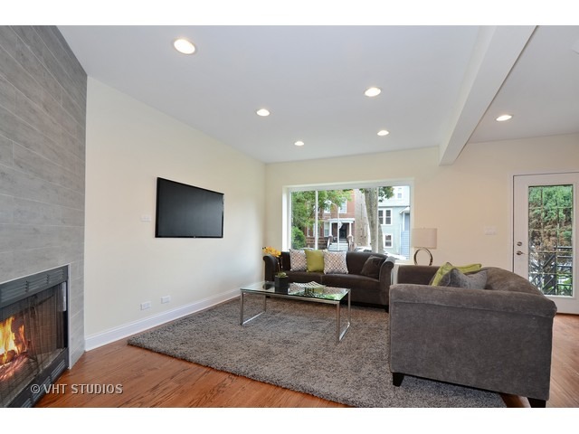 3323 North Troy Street Chicago, IL 60618 - Photo 2 of 25 a living room with furniture and a flat screen tv