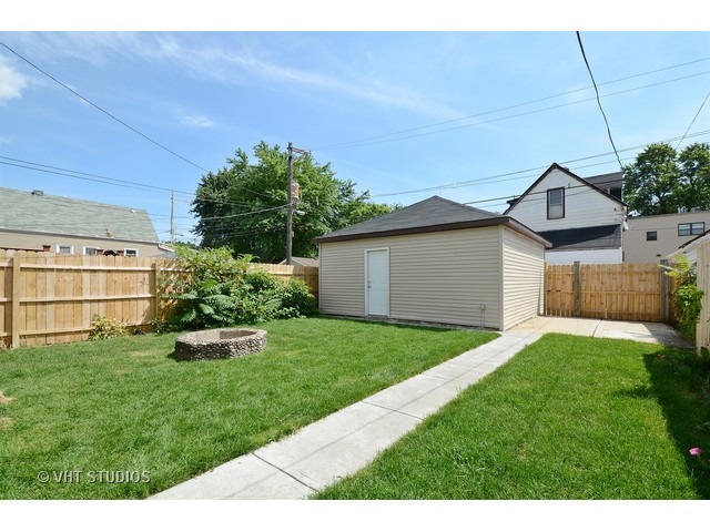 3323 North Troy Street Chicago, IL 60618 - Photo 22 of 25 a backyard of a house with plants and large tree