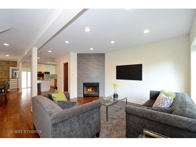 3323 North Troy Street Chicago, IL 60618 - Photo 3 of 25 a living room with furniture and a fireplace