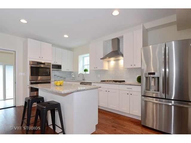 3323 North Troy Street Chicago, IL 60618 - Photo 5 of 25 a kitchen with kitchen island a counter top space stainless steel appliances and cabinets