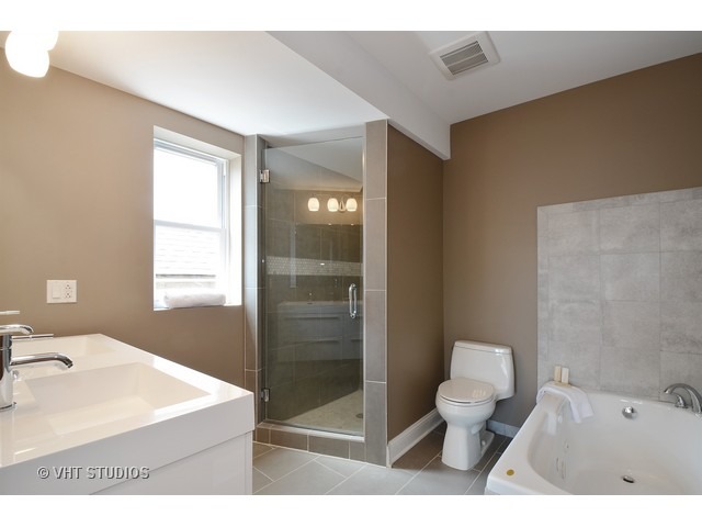 3323 North Troy Street Chicago, IL 60618 - Photo 10 of 25 a bathroom with a sink toilet a shower and bathtub