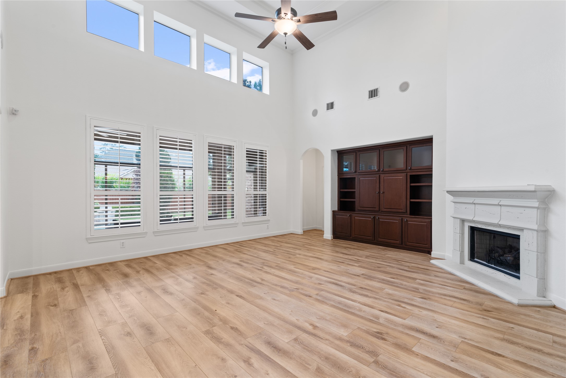 155 South Arrow Canyon Circle Spring, TX 77389 - Photo 18 of 49 The light coming through the windows flood the space with soft, natural light, creating a bright and uplifting atmosphere. The ground is anchored by LVP flooring in warm tones, which reflects the incoming daylight to make the room feel more expansive and relaxing.