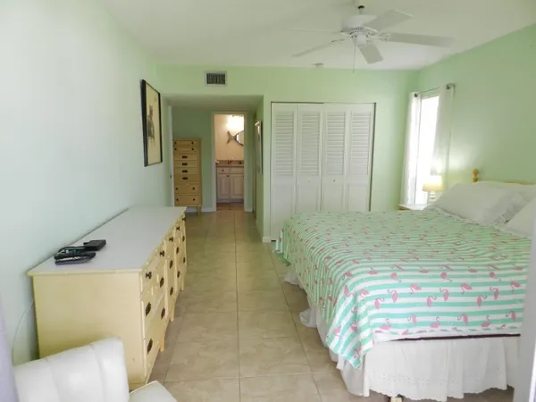 a bedroom with a bed and a mirror