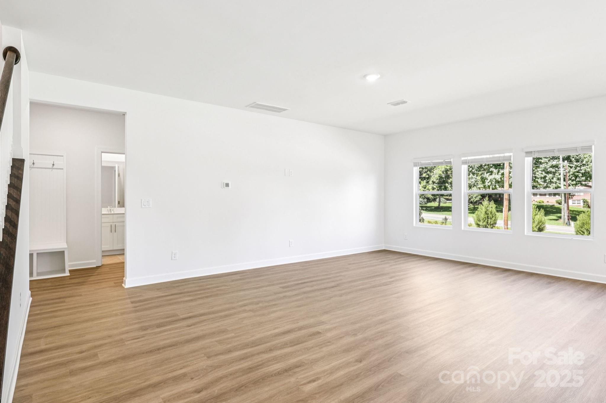161 Murphy Mdw Road Mocksville, NC 27028 - Photo 3 of 29 an empty room with wooden floor and windows