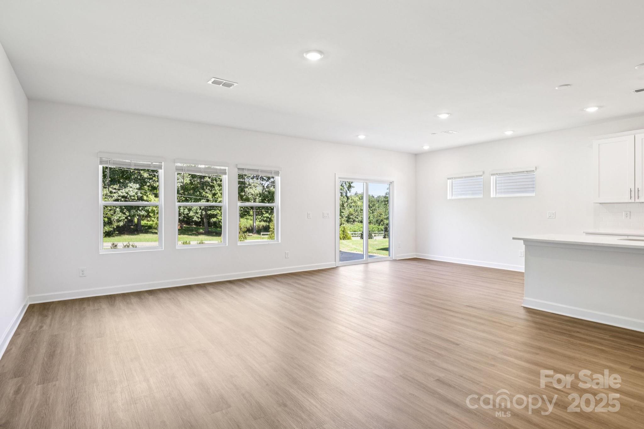 161 Murphy Mdw Road Mocksville, NC 27028 - Photo 4 of 29 a view of empty room with wooden floor and fan